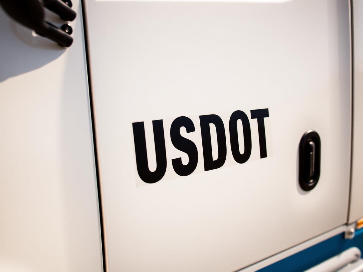 USDOT vinyl lettering applied to a white truck cab door